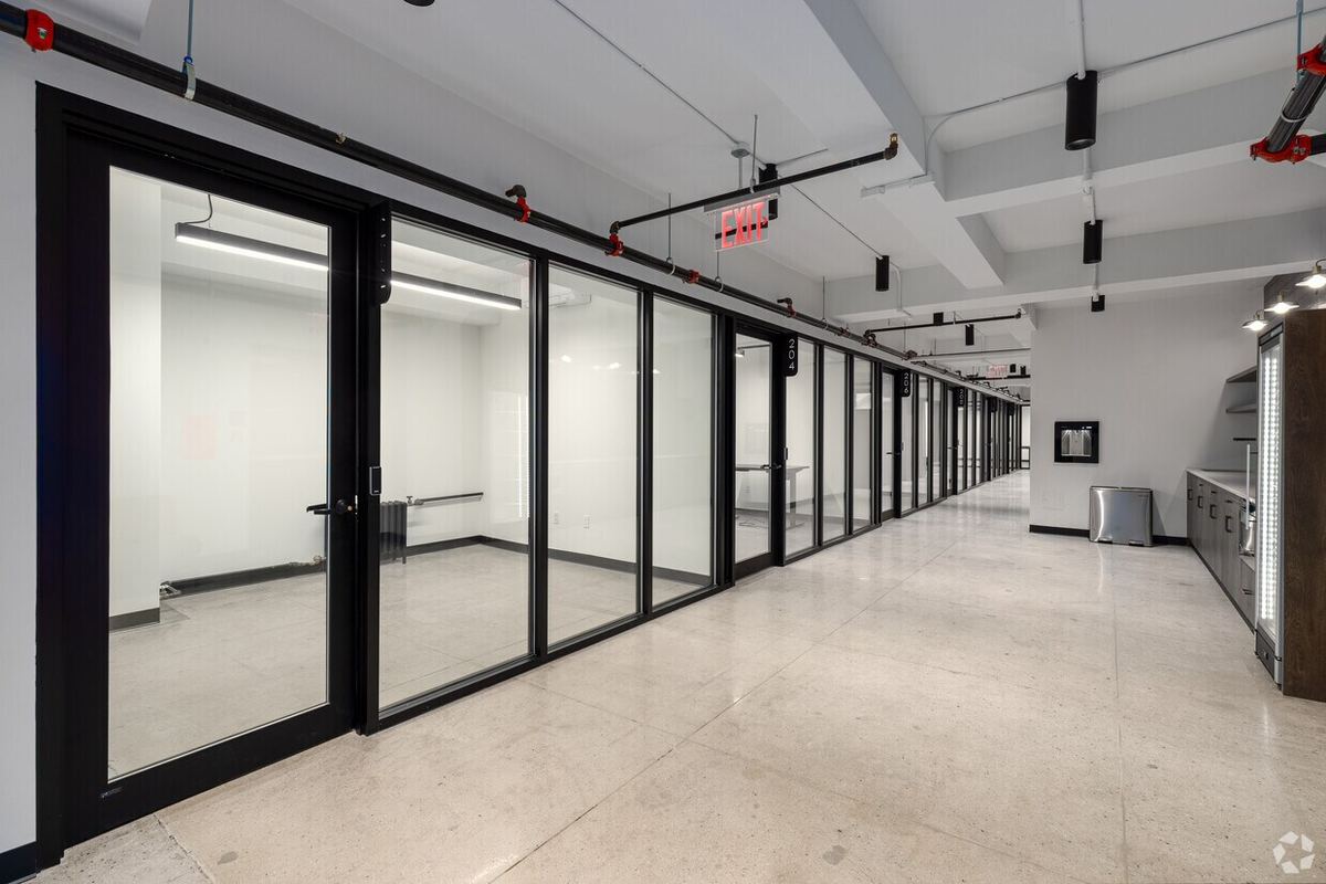 A row of private, glass-door offices along the corridor